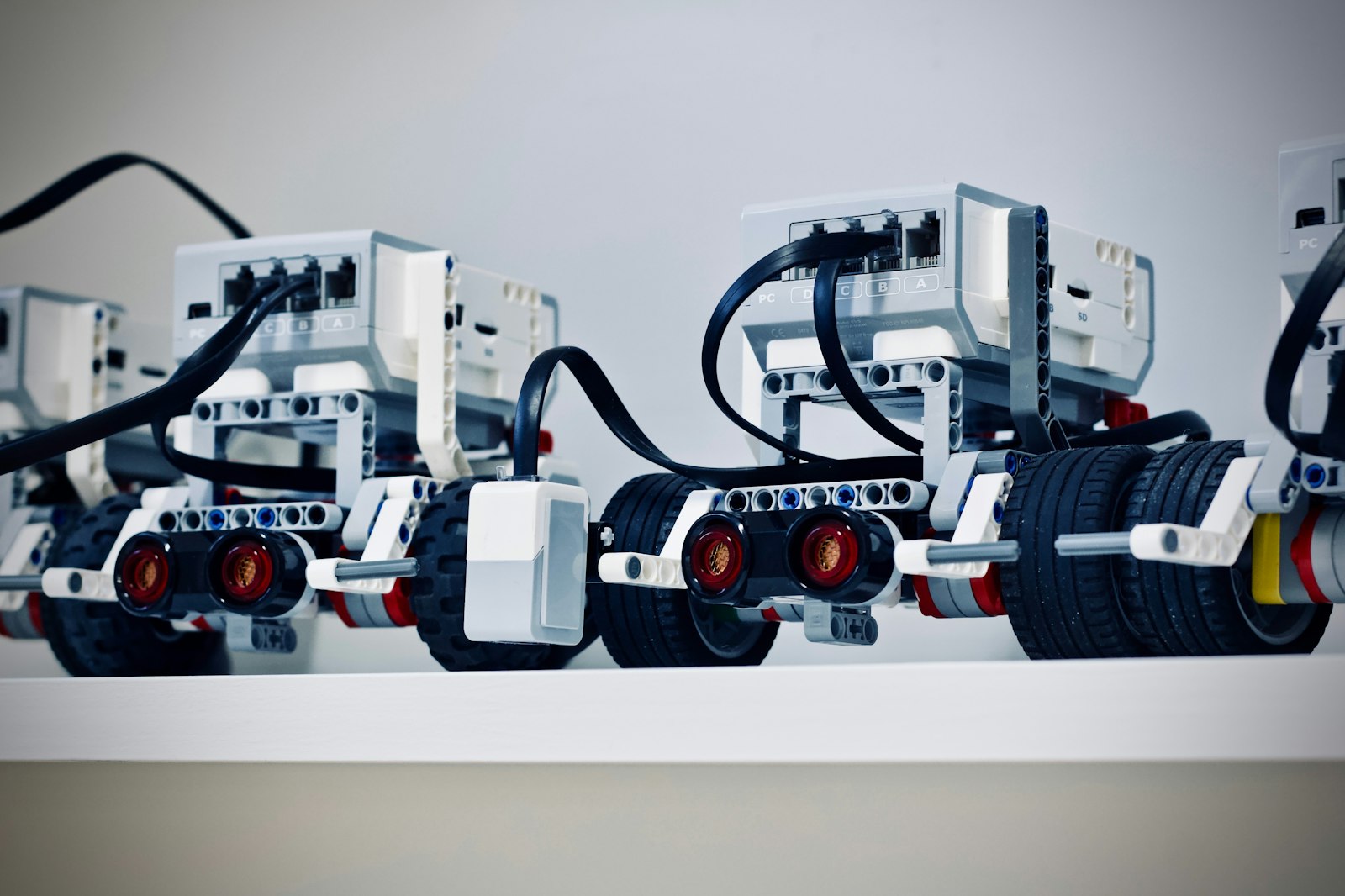 Kids building small robots with motors and wheels at a STEM camp